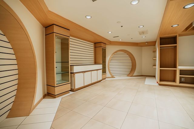 Showroom floor with glass display cases and circular accent wall