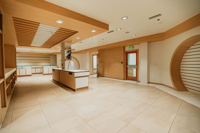 Wide view of showroom space with wood ceiling details
